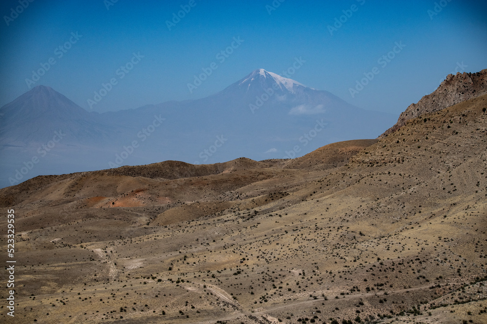 landscape with the top of Mount Ararat in the distance with a snow cap view from the territory of Armenia