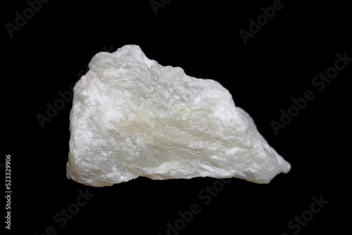 Raw Talc (talcum) stone on dark background, talc is a clay mineral used in many industries ex. powder, cosmetic, paint  