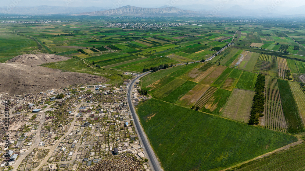 panoramic view of the green plain in the foothills against the sky in Armenia taken from a drone