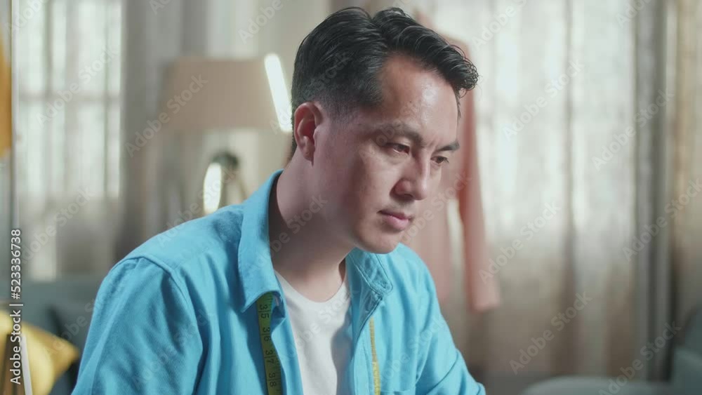 Close Up Of Asian Male Designer Working On A Laptop And Drinking Coffee While Designing Clothes In The Studio
Close Up Of Asian Male Designer Working On A Laptop And Drinking Coffee While Designing Clothes In The Studio