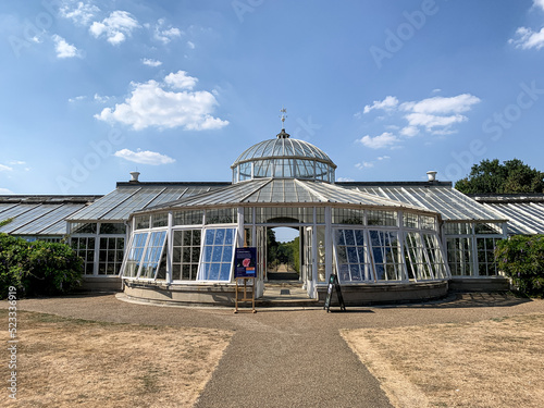 Green house at Chiswick House and Gardens, London. Fragment of facade of Grade1 listed greenhouse housing historic camelia plants at Chiswick House and Gardens in West London. Sunny summer day