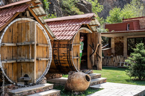 large wine barrels converted into houses for spending the night and rest rooms in the shadow of the mountains in Armenia