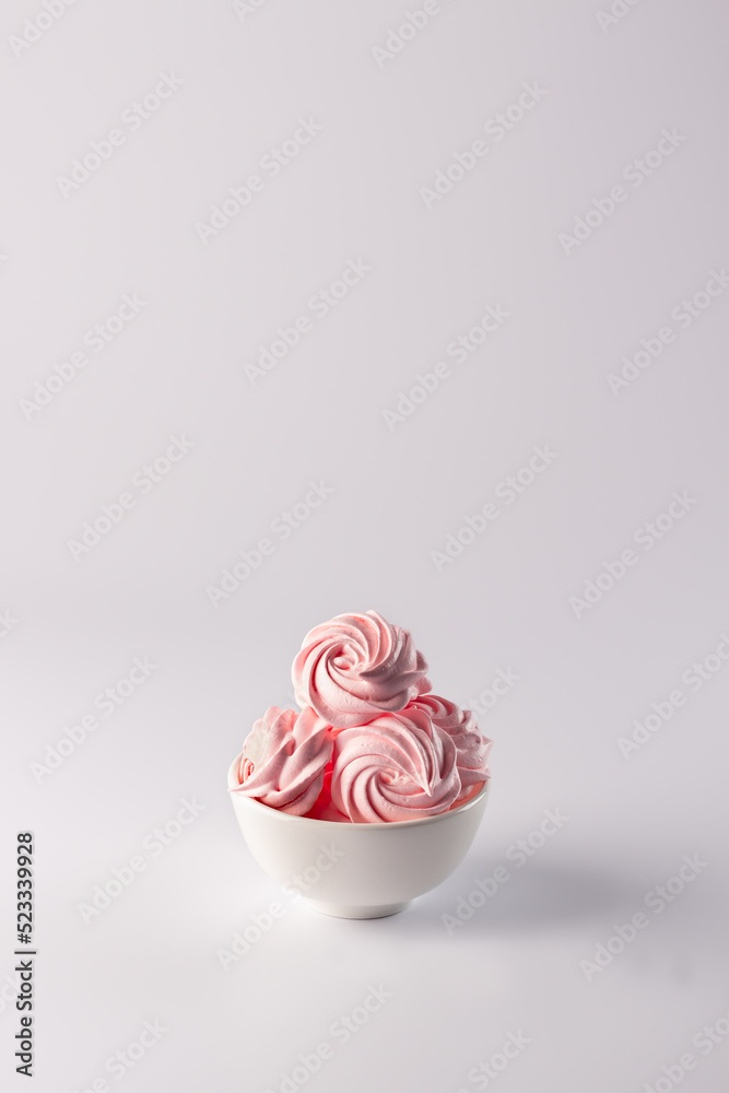 Meringue crispy. Air dessert in pink color on a white background. Marshmallow raspberry. Meringue crispy. Air dessert in pink color on a white background. Marshmallow raspberry.