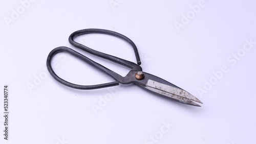 Vintage scissors close-up on a white background, video tools.