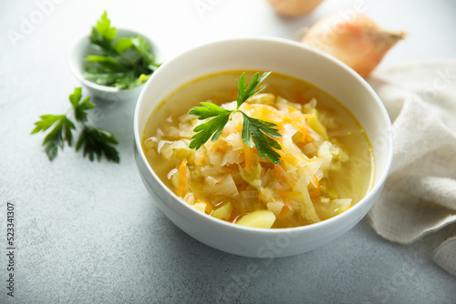 Traditional homemade sauerkraut soup with fresh parsley