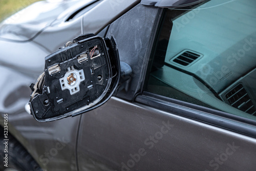a broken rearview mirror on a passenger car