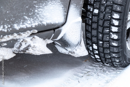 a car wheel with winter tires in the snow close-up