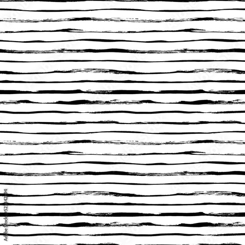 Seamless pattern with thin brush lines. Black and white seamless vector sailor stripes pattern. Classic black and white hand drawn stripes ornament. Simple horizontal lines. Tribal or ethnic ornament