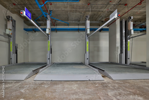 Empty Space in Automatic Elevator double stack car park. Hydraulic lift. Empty garage. Hydraulic machine for lifting car indoor parking.
