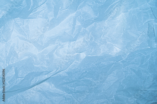 Texture of crumpled paper, pale blue empty background