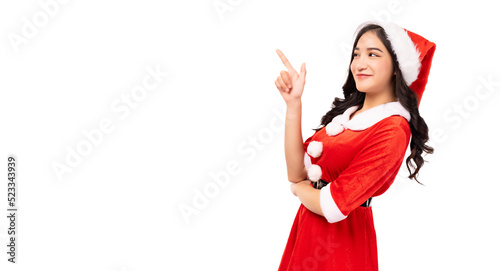 Young woman wearing red Santa Claus outfit and Santa Claus Hat pointing up to copy space isolated on white background Christmas x-mas winter happiness holiday and party concept 