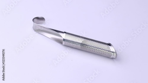 Tea infuser close-up on a white background, video of kitchen accessories.
