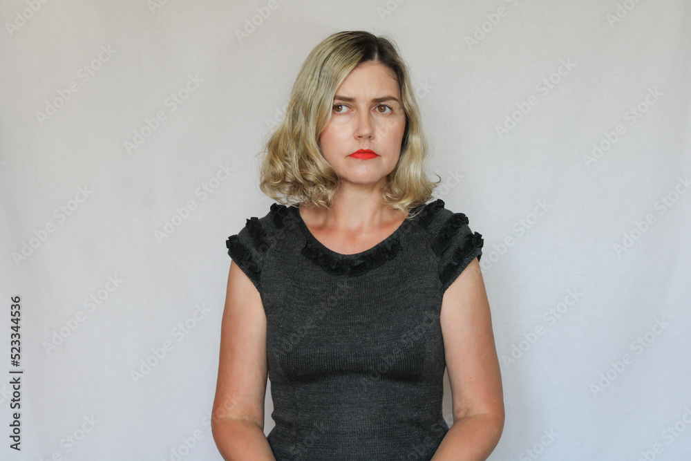 Fototapeta premium Beautiful middle-aged blond woman on a white background