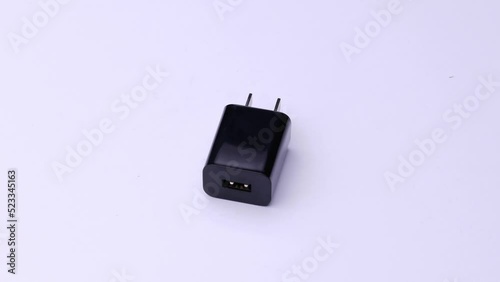 Plug charger for phone up-front on white background, video electronics.