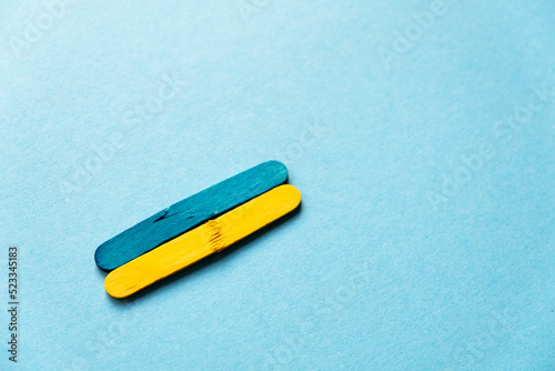 wooden sticks in the colors of the flag of ukraine are broken. War in Ukraine. The pain of Ukraine. Politics