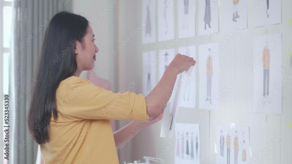 Side View Of Asian Female Designer With Sewing Machine Putting A Picture On The Wall While Designing Clothes In The Studio
Side View Of Asian Female Designer With Sewing Machine Putting A Picture On The Wall While Designing Clothes In The Studio