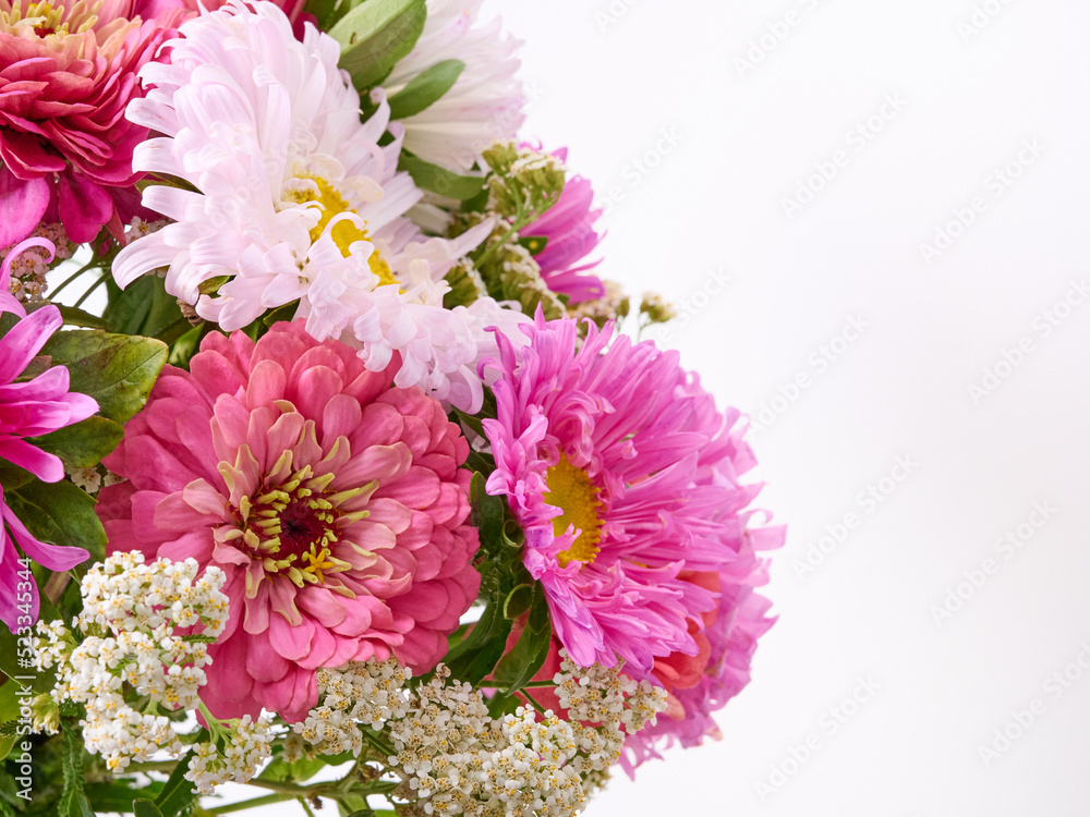 A bouquet of bright flowers on a light background.