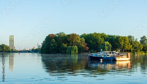 Boats are anchored in a bay on Rummelsburg lake in Berlin.