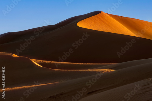 The dunes of Erg Chegaga at sunset. Erg Chegaga (or Chigaga) is one of two major Saharan ergs of the Sahara in Morocco. It is the largest and wildest of Morocco. photo