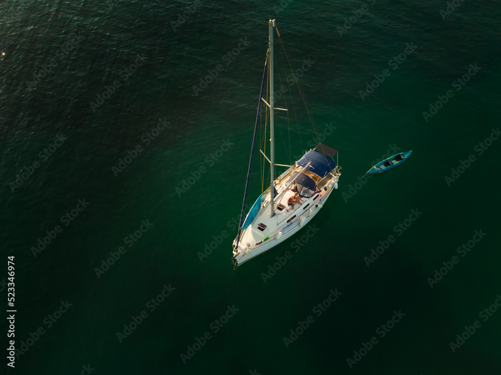 Aerial drone view of a sailboat anchored at Notre Dame beach in Porquerolles island in Var, France