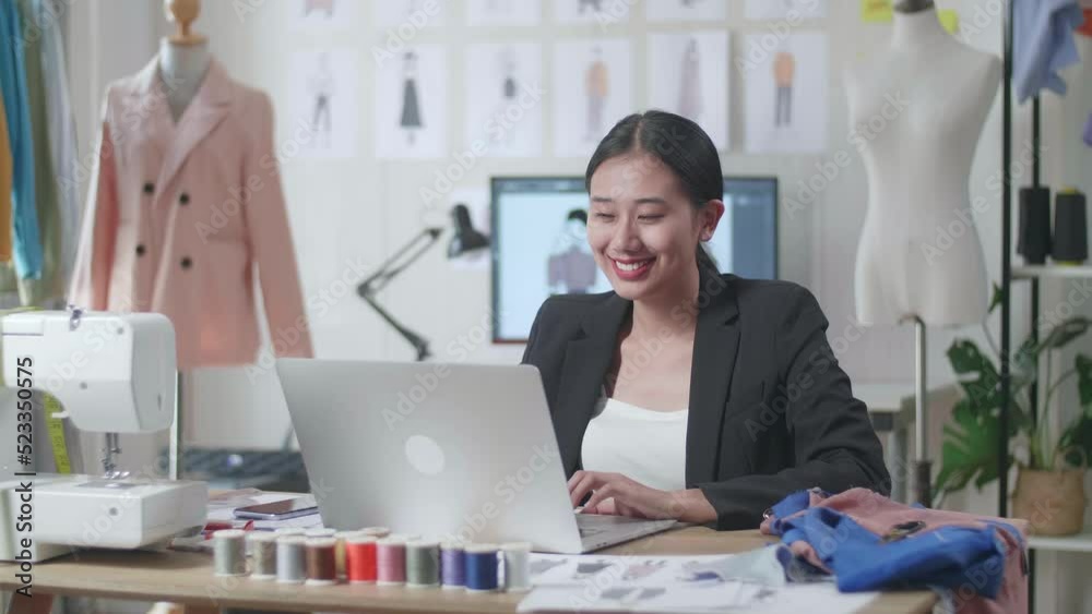 Smiling Asian Female Designer In Business Suit Working On A Laptop While Designing Clothes In The Studio
Smiling Asian Female Designer In Business Suit Working On A Laptop While Designing Clothes In The Studio
