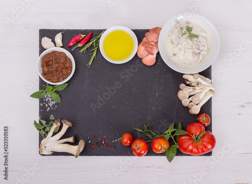 Fresh mediterranean cuisine ingredients on a black plate 