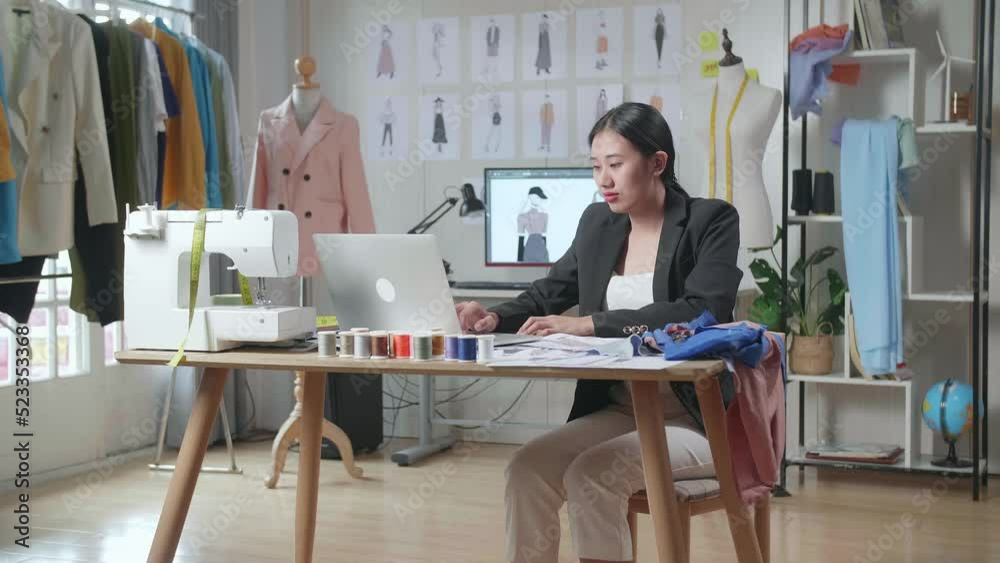 Asian Female Designer In Business Suit Working On A Laptop, Yawning, And Sleeping While Designing Clothes In The Studio
Asian Female Designer In Business Suit Working On A Laptop, Yawning, And Sleeping While Designing Clothes In The Studio