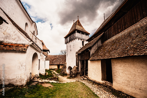 Viscri, Romania: Blue old painted traditional house from village, Transylvania, German Saxon community. Unesco. The Viscri fortified church photo