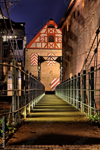 Night view over the bridge Kettensteg over the river Pegnitz in the old town of Nuremberg. 