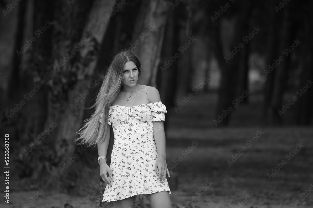 Young woman in dress at the forest in black and white Young woman in dress at the forest in black and white