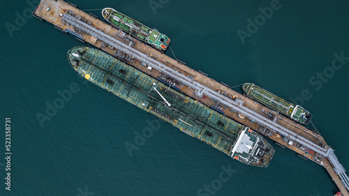 Aerial view tanker ship vessel unloading at port, Global business logistic import export oil and gas petrochemical with tanker ship transportation oil from dock refinery.