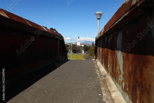 The railway station bridge in Worcester, South Africa, showing a church steeple in the distance. photo