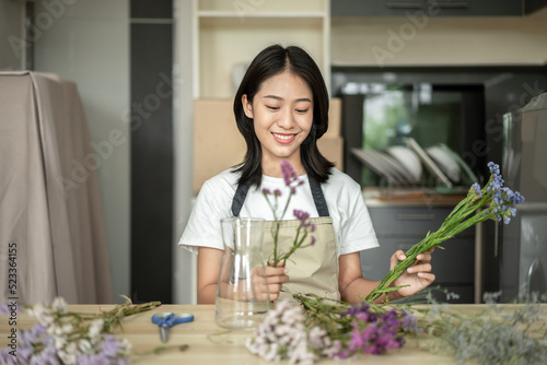 Weekend with her hobbies, Asian woman arranges a bouquet of flowers to decorate her home and beautify, Artificial flower arrangement, living room decoration ideas, Flowers bunch, Arts and crafts