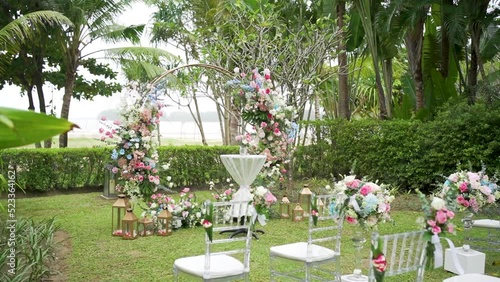 Decorated wedding arch chairs pastel ceremony garden. photo