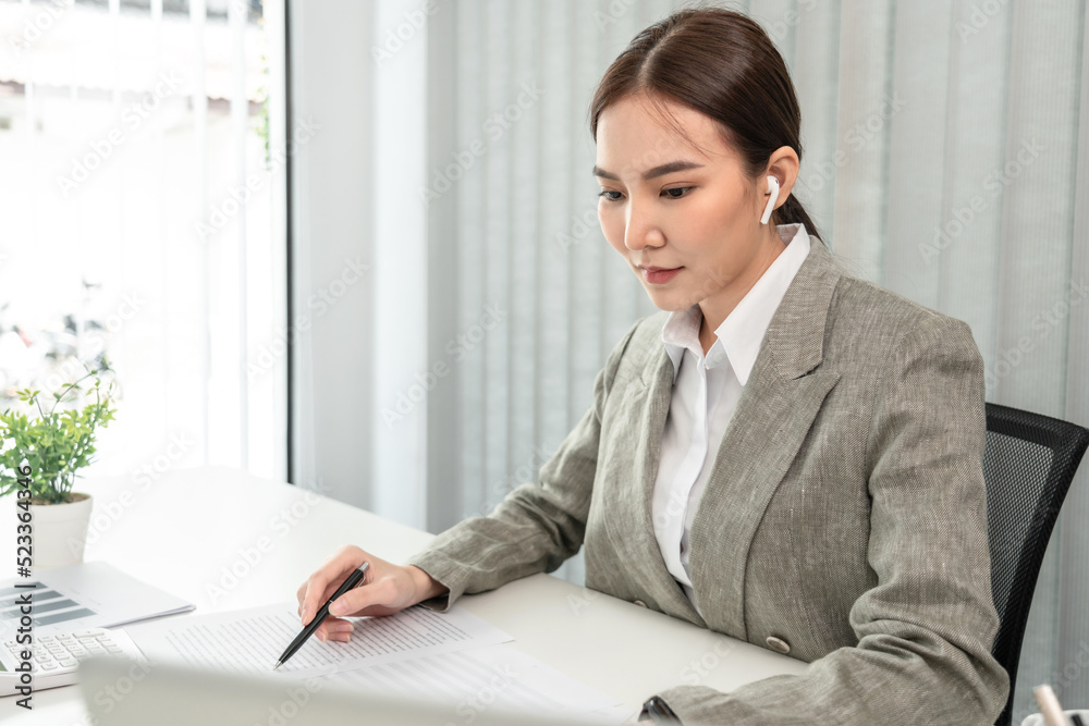 Asian business women are analyzing company sales statistical graphs to develop them further., Using laptops and data graphs to work, Tax, Vat , Professional female marketer Asian business women are analyzing company sales statistical graphs to develop them further., Using laptops and data graphs to work, Tax, Vat , Professional female marketer