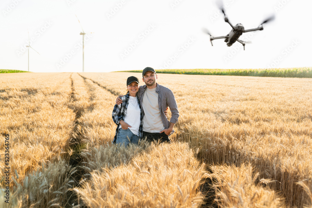 Two farmer with drone on the wheat field. Smart farming and precision agriculture Two farmer with drone on the wheat field. Smart farming and precision agriculture