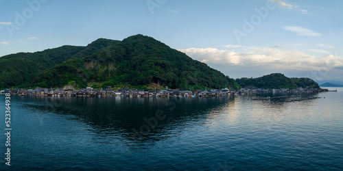 Houses in small fishing village between water and mountain at blue hour