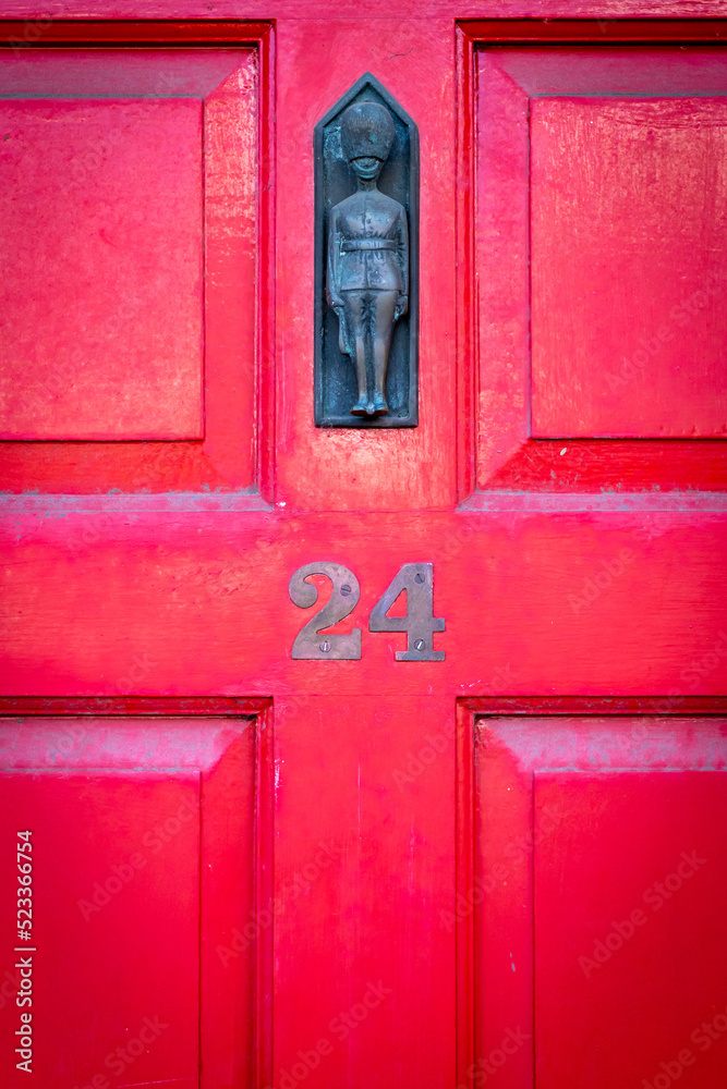 House number 24 in red with Palace Guard