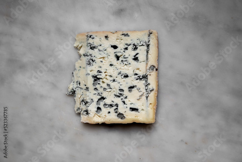 A slice of blue cheese on Carrara marble photo