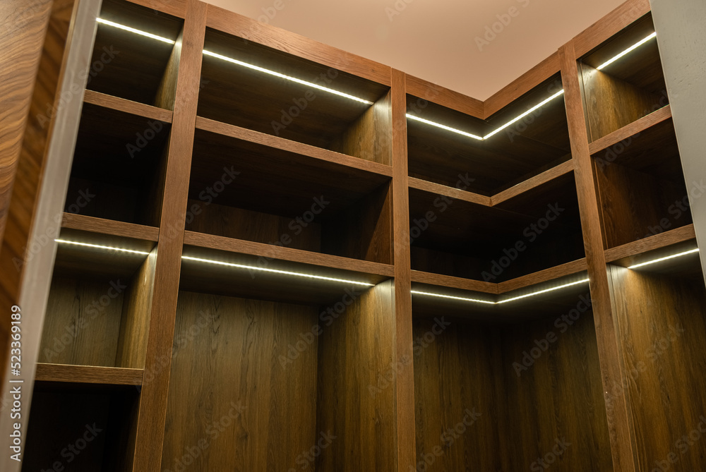 Big wardrobe room in modern apartment or hotel. large wooden locker room Big wardrobe room in modern apartment or hotel. large wooden locker room