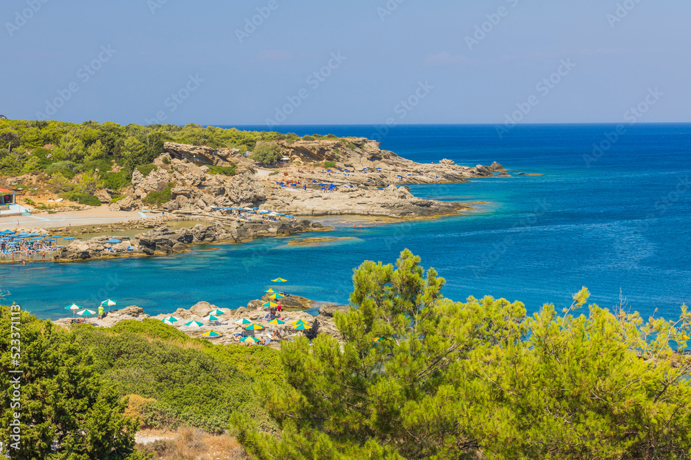 Beautiful view of rocky coast of Mediterranean sea with equipped beaches. Greece.