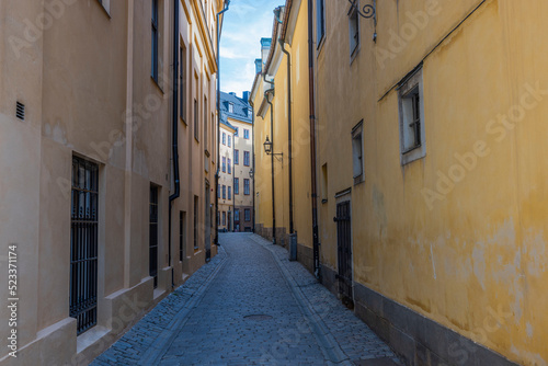 Close up view of narrow street between two yellow buildings. Sweden. Stockholm.  © Alex