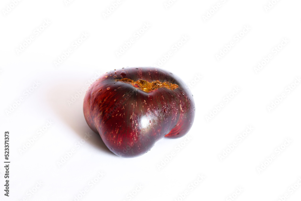 Fresh ripe black tomato isolated on a white background. Krim or Kumato tomatoes. Fresh ripe black tomato isolated on a white background. Krim or Kumato tomatoes.