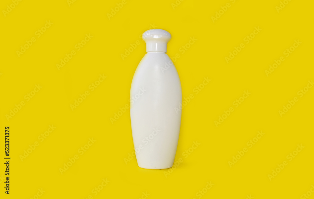 Bottle for shampoo on a bright yellow background Bottle for shampoo on a bright yellow background