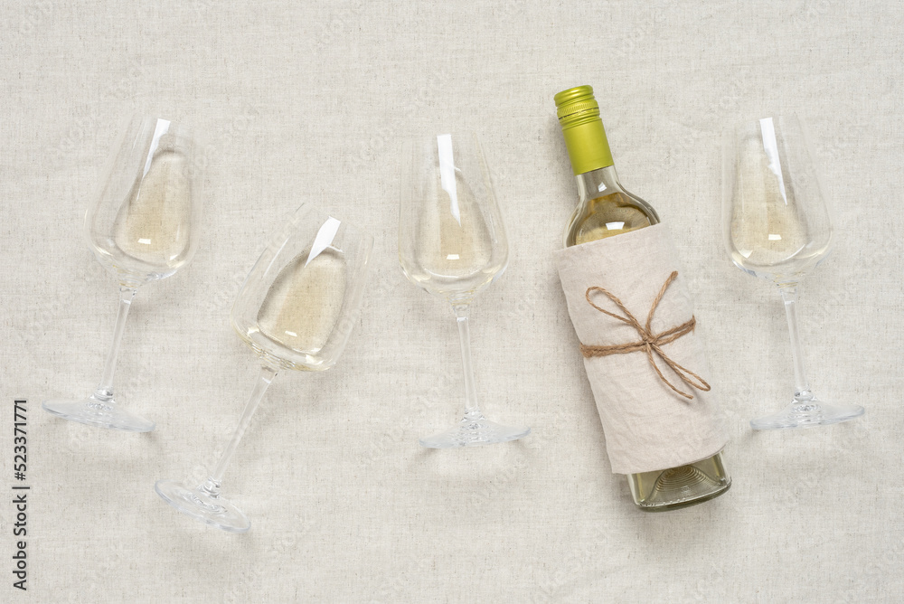 White wine flat lay. Beige textile background. View from above. White wine flat lay. Beige textile background. View from above.