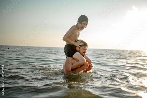 Sticker Father and son swim in the sea