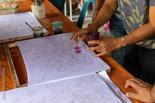 Painting watercolor on the fabric to make Batik, Making Batik, painting traditional batik, Batik-making is part of Thailand culture and tourist attraction
