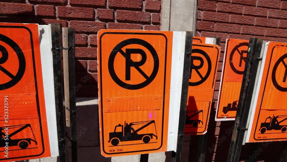 slow-motion-movie-showing-lots-of-no-parking-signage-and-street