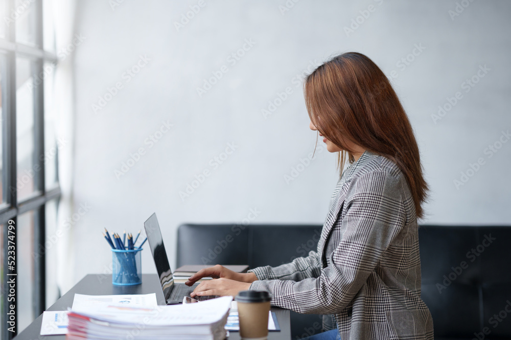 Beautiful Asian businesswoman working on laptop computer in the office. Beautiful Asian businesswoman working on laptop computer in the office.