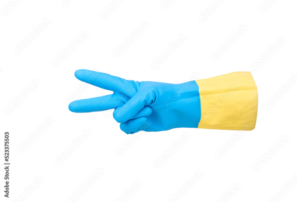 Rubber glove in yellow-blue color under the flag of Ukraine with two fingers showing victory gesture isolated on white background